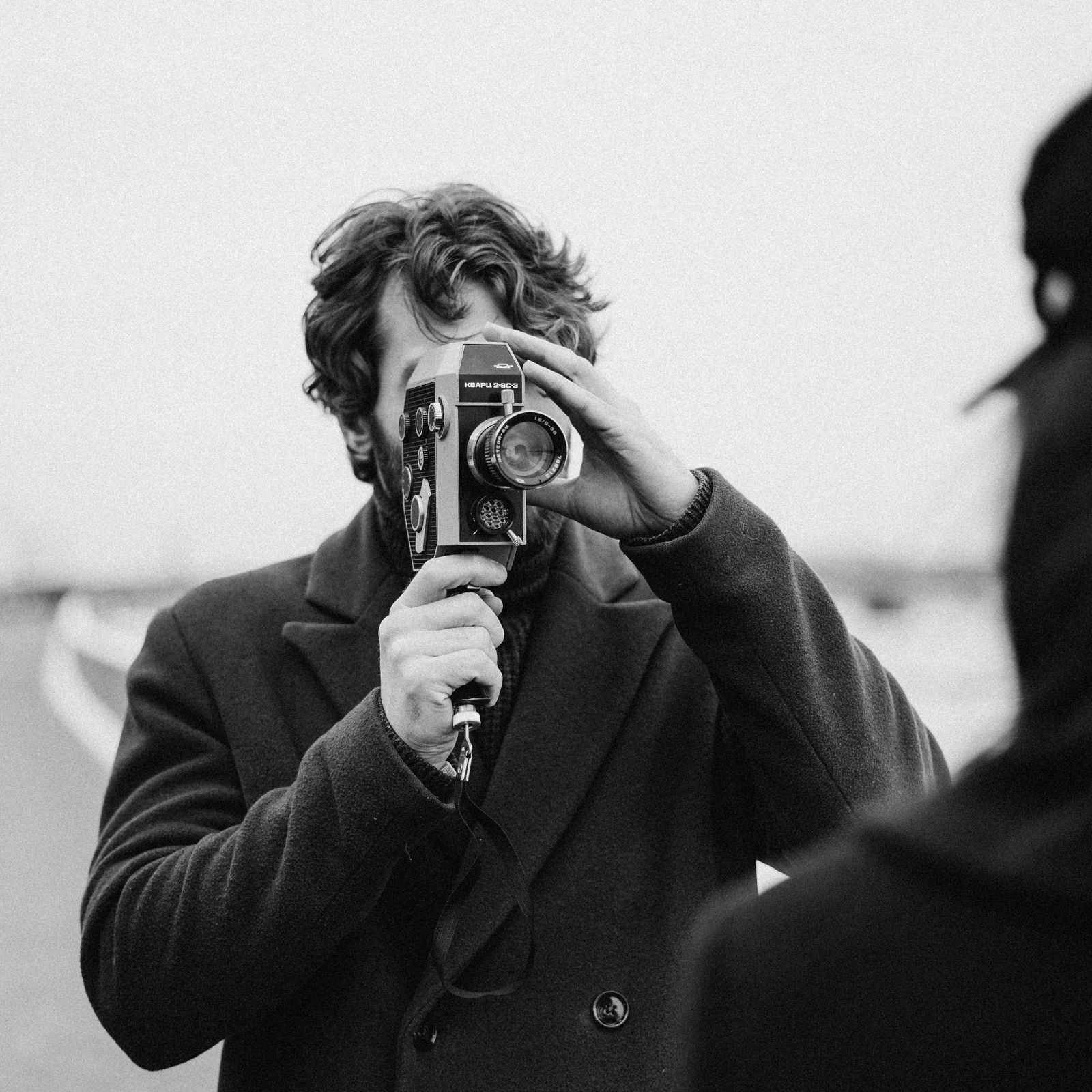 Editor framing a shot with a camera on location